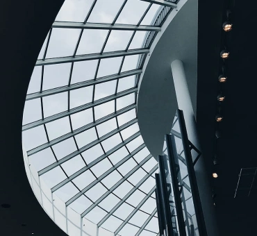 Part of the modern interior with focus on the glass rounded square-segmented ceiling.